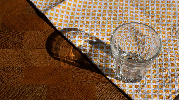 istock Vodka Shot on Wooden Table with Napkin in Sunlight 2215447126