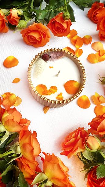 Romantic Flat Lay with Orange Roses and Scented Candle