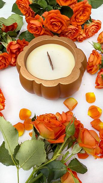 istock Pumpkin-Shaped Candle and Orange Roses Flat Lay 2215448301