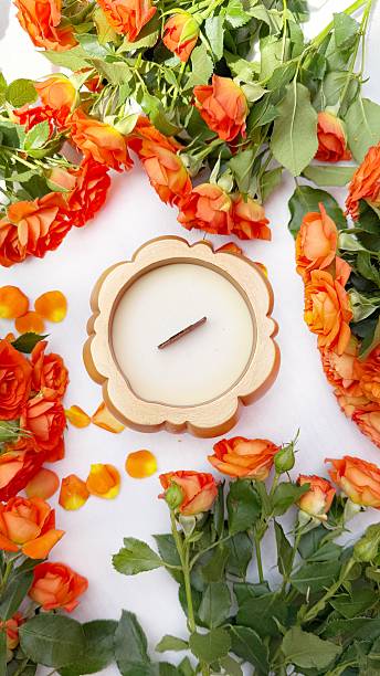 istock Pumpkin-Shaped Candle and Orange Roses Flat Lay 2215448313