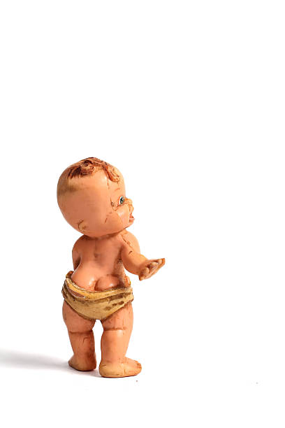 used baby doll standing isolated on white background