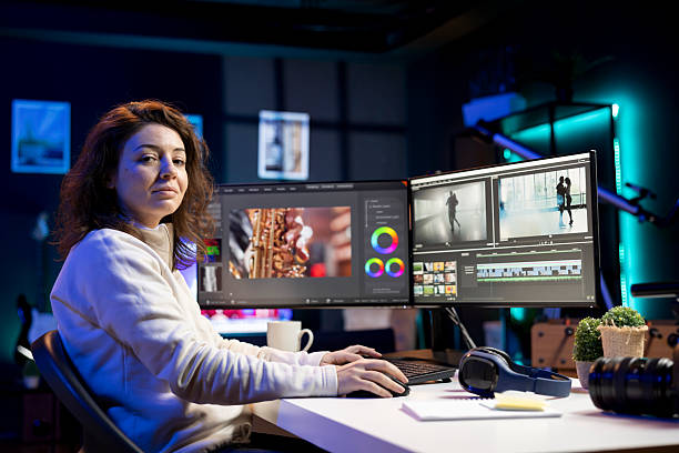 Portrait of smiling video editor arranging recorded stock clips Portrait of smiling video editor arranging recorded stock clips into seamless whole in creative media studio using computer. Upbeat videographer assembling recorded footage into finished project female film editor stock pictures, royalty-free photos & images