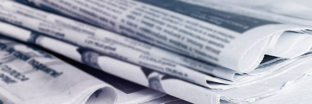 istock Newspapers, world news information concept, close-up, panoramic 2215450528