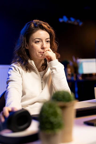 Woman using mouse to edit movie project footage in personal office Video editor selecting key frames to use while doing video montage, working from home studio on computer. Woman using mouse to edit movie project footage in personal office female film editor stock pictures, royalty-free photos & images