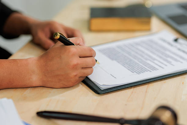 istock Signing in acknowledgment and conducting legal representation correctly. 2215451750