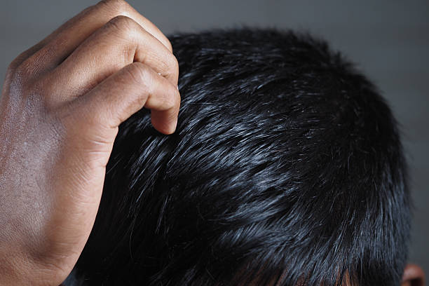 Person scratching their head in deep thought