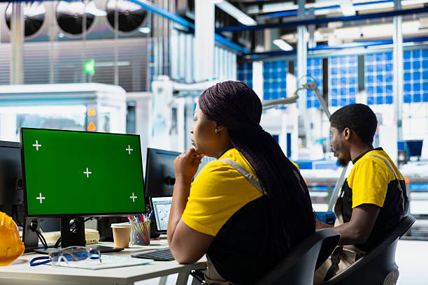 istock Manufacturing plant employee reviews data on green screen pc 2215454102