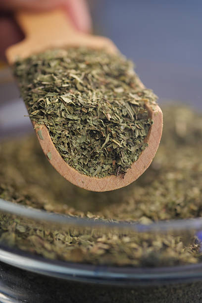 istock Measuring dried herbs in the kitchen for cooking 2215454706