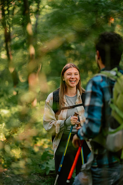 istock Hikers walking and talking in the woods 2215455713