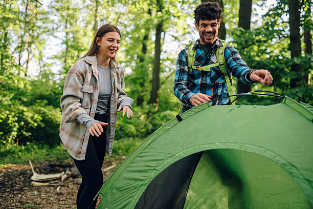 istock Young adults enjoying camping in the forest 2215455797