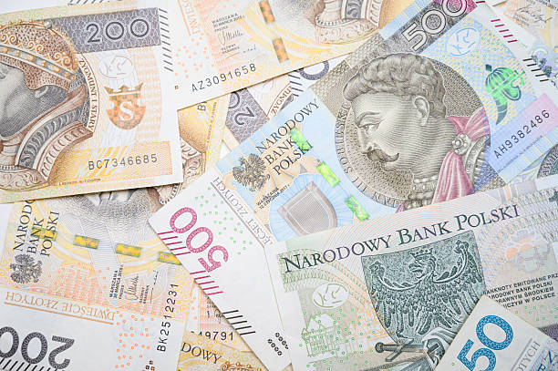 istock Polish Zloty Banknotes in Random Arrangement on White Table Surface. 2215456015
