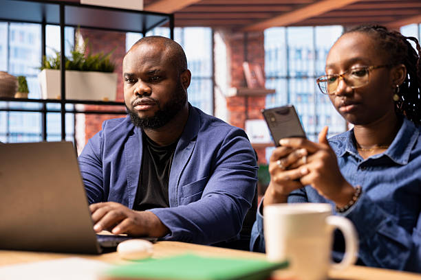 istock African American couple in a modern flat collaborate on a consulting project 2215456983