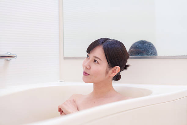 istock Middle woman relaxing in a bath at home 2215460765