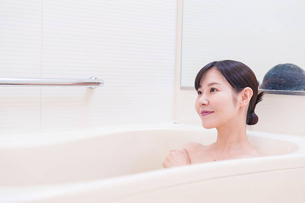istock Middle woman relaxing in a bath at home 2215460768