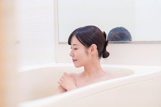 istock Middle woman relaxing in a bath at home 2215460770