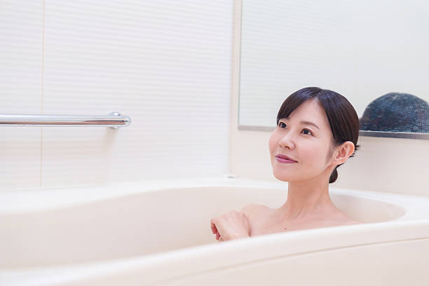 istock Middle woman relaxing in a bath at home 2215460772