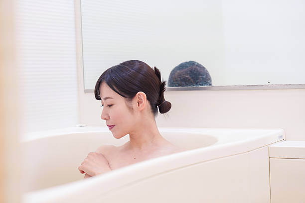 istock Middle woman relaxing in a bath at home 2215460773