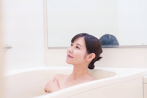 istock Middle woman relaxing in a bath at home 2215460774