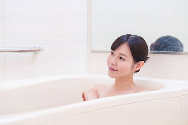 istock Middle woman relaxing in a bath at home 2215460775