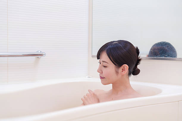 istock Middle woman relaxing in a bath at home 2215460778