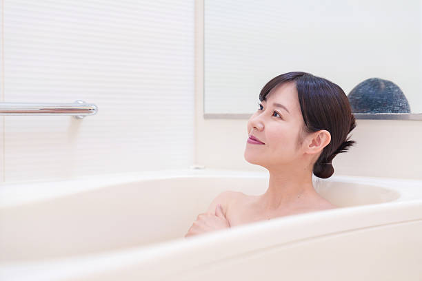 istock Middle woman relaxing in a bath at home 2215460779