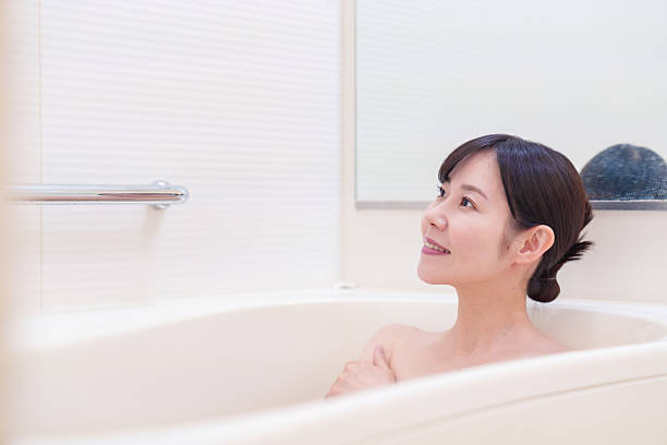 istock Middle woman relaxing in a bath at home 2215460781