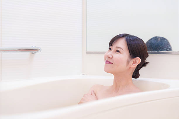 istock Middle woman relaxing in a bath at home 2215460783