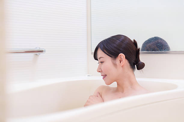 istock Middle woman relaxing in a bath at home 2215460786