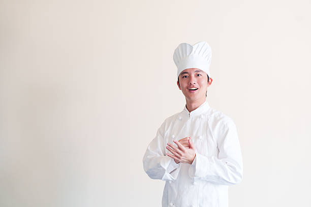 happy chinese man standing in the kitchen of an asian restaurant