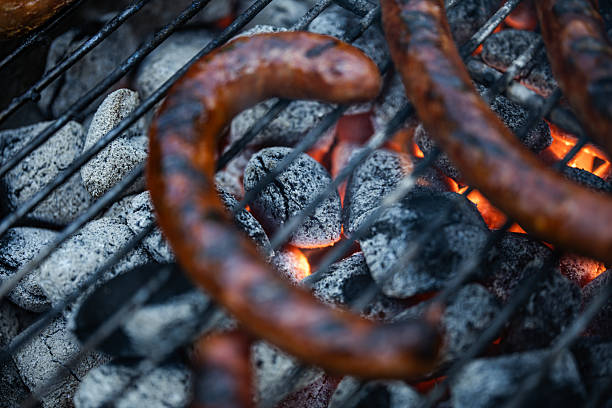 Buenos Aires, Argentina, - October 9th 2016 : Argentine gaucho controlling the sausages on a big grill during the championship of Argentine barbecue, national dish called \