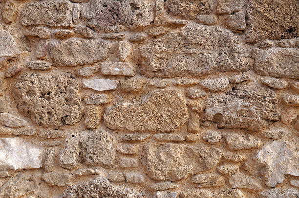 istock ancient stone wall closeup for natural beige vintage background 2215463972