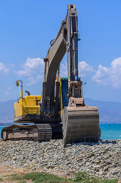 istock Excavator Levels Sand on Coast 2215464114