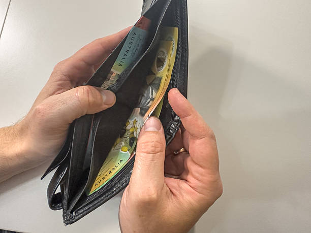 istock male hand holding Australian Dollar in the wallet 2215465772