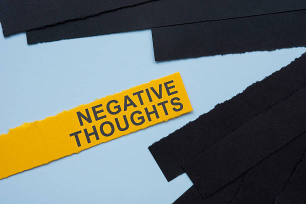 istock Negative thoughts text with black paper strips. Inner struggle and emotional distress. 2215465894