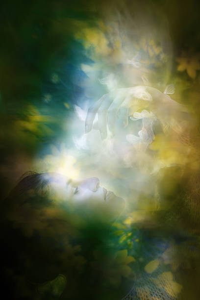A young woman, in blurred yellow flowers, lets white lace butterflies playfully fly between her fingers.