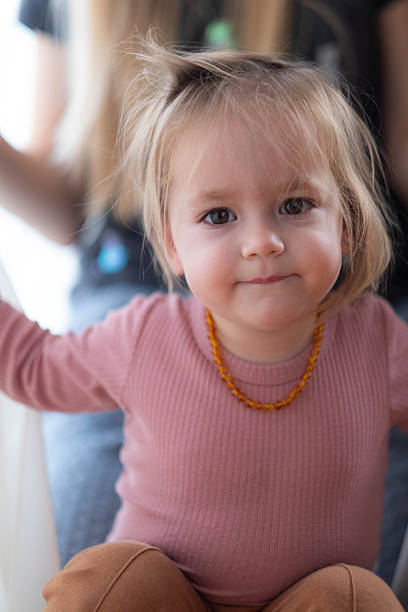 The girl is looking at the camera.