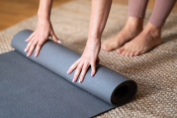 istock the women finished training and picked up the mat on which she trained 2215476647