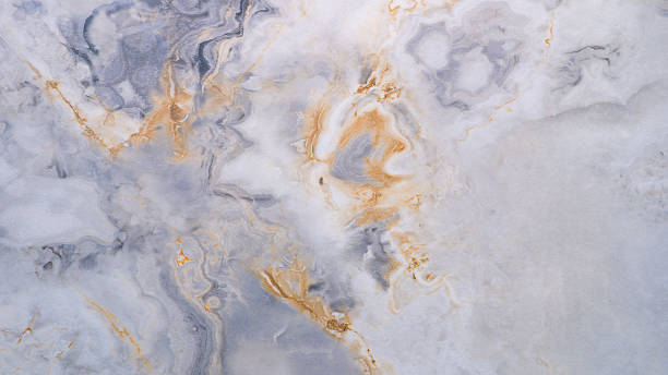 istock A marble wall with a blue and white swirl pattern. The marble is a light blue color with a yellowish tint 2215477167