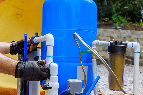 istock Installing artesian water well system in residential backyard on sunny afternoon 2215477334