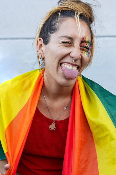 istock Celebrating pride with joyful expression and a rainbow flag in a vibrant outdoor setting 2215481996