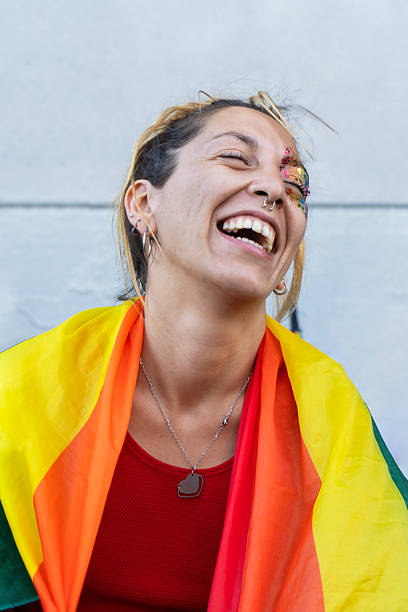 istock Joyful lesbian celebrating diversity wrapped in a rainbow flag 2215482007