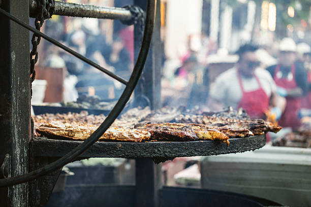 A BBQ grill with various cuts of meat on an outdoor grill