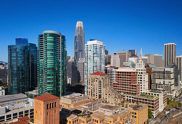 Elevated view of San Francisco highrise buildings in the southern area of the Financial Districtr with the Salesforce Tower and a blue sky in the background.