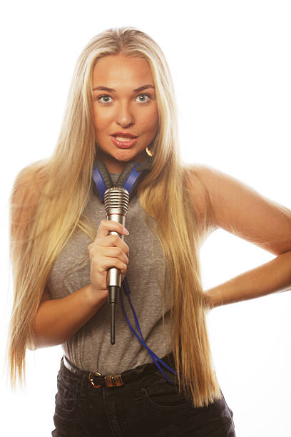 Beautiful woman artist over the background of colorful light on the stage