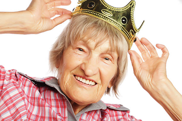 istock Senior woman wearing crown doing funky action 2215484861