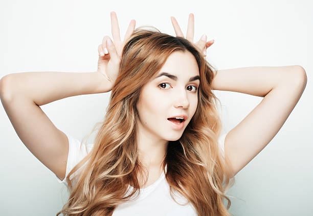 istock Young beautiful woman posing with white t-shirts, ower white background 2215484907
