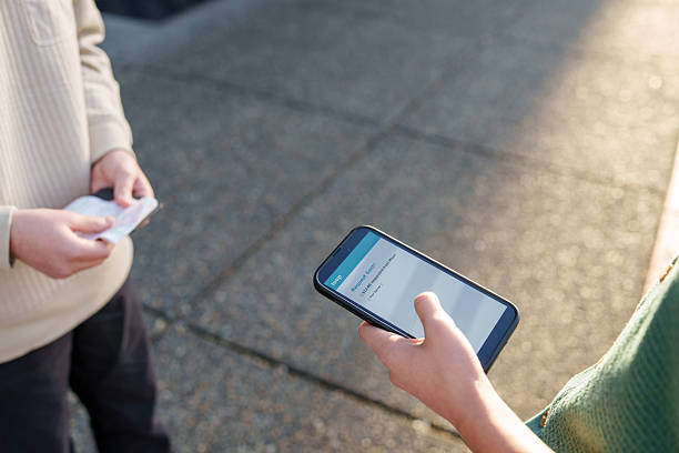 istock Teenager using digital wallet to send payment request to a friend 2215486322