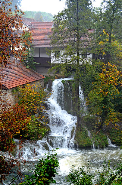 Rastoke Croatia. October 8 2015. Scenic cascade running beside rustic houses during a misty rainy day in picturesque village
