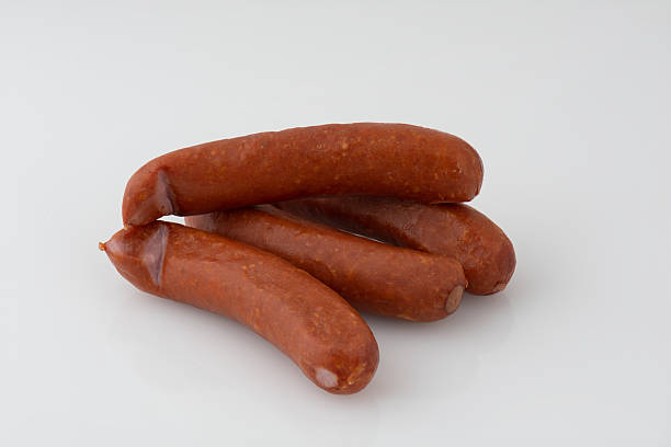 istock bright red sausage isolated nature background with clipping path 2215487042