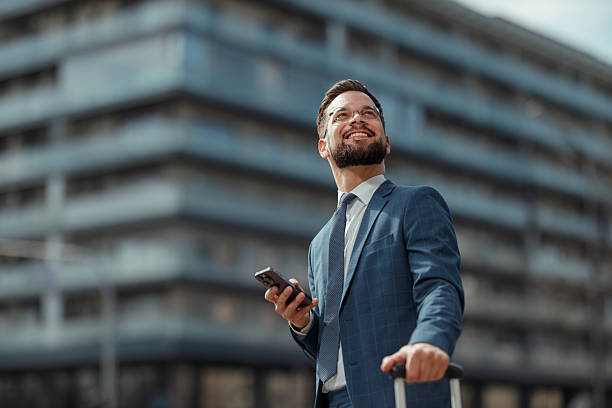 istock Smiling Businessman Using Smartphone Outdoors 2215487293